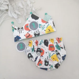 Conjunto corona cumpleaños y cubrepañal monstruos mint